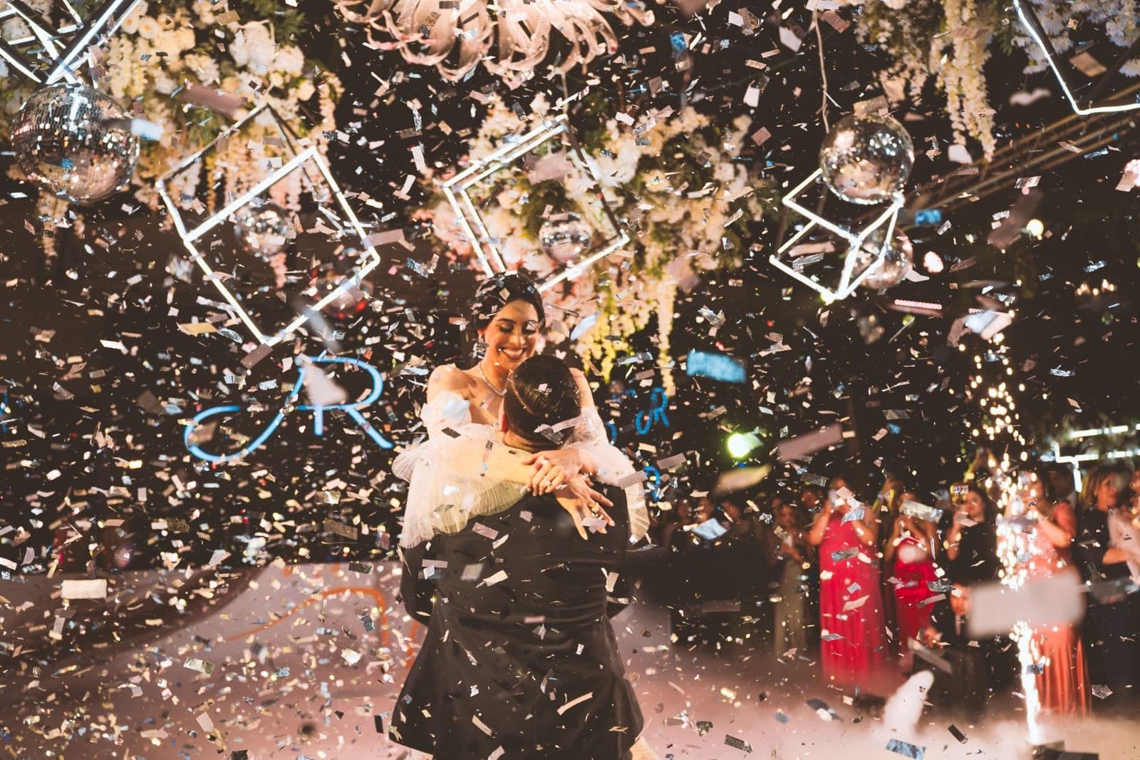 Couple celebrating beneath falling confetti and special effects