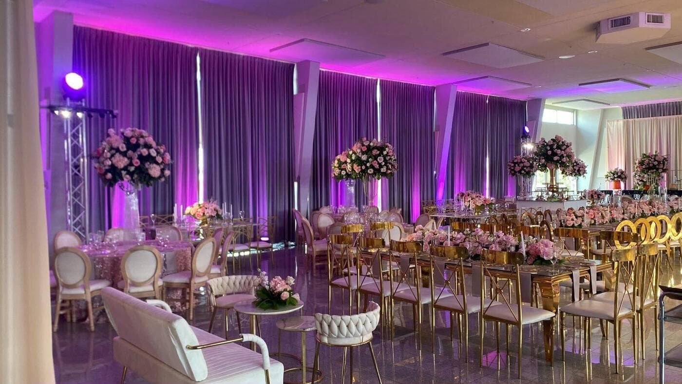 Elegant event venue transformed with purple uplighting